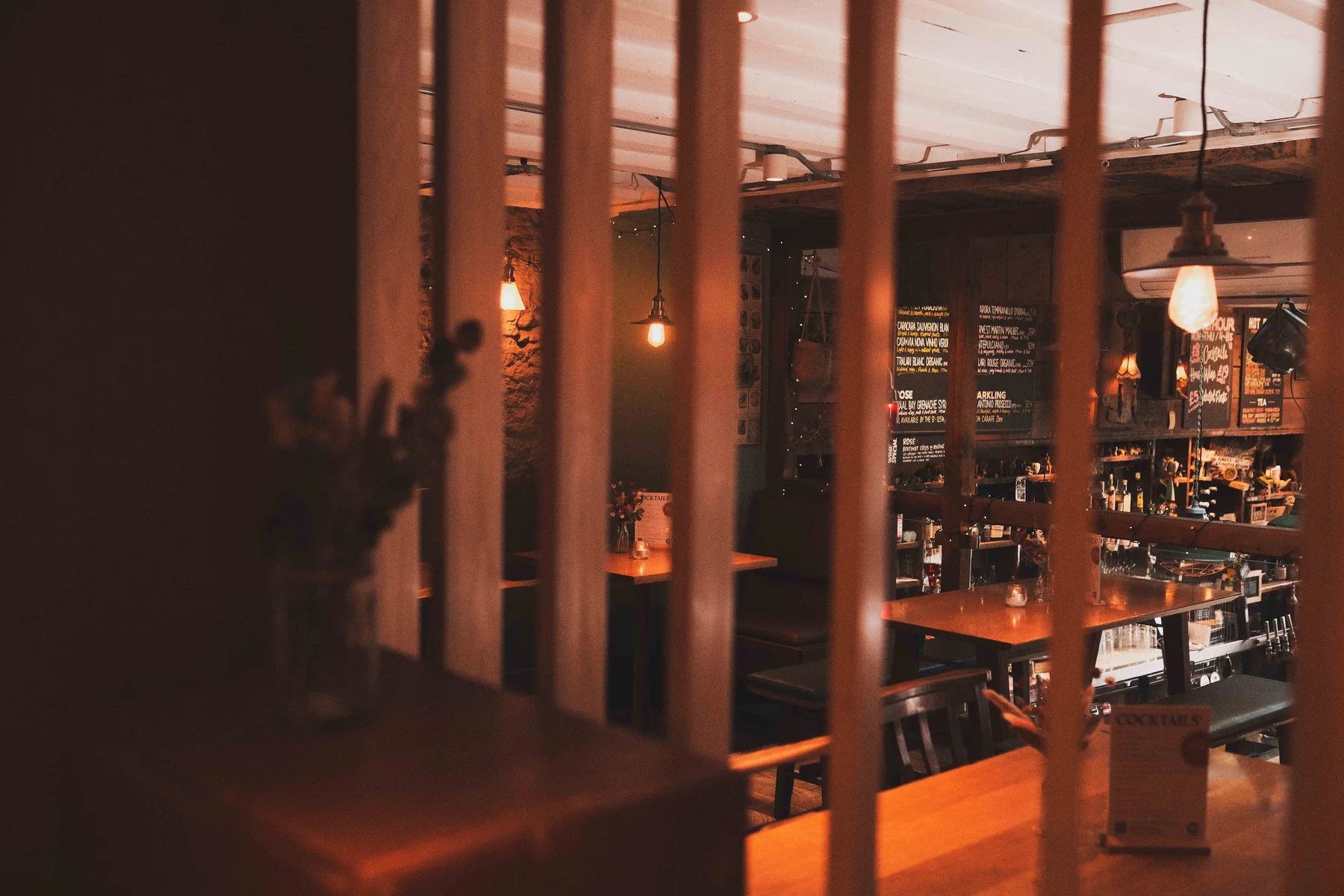 The Gallimaufry interior, looking through the upstairs wooden screen towards the bar